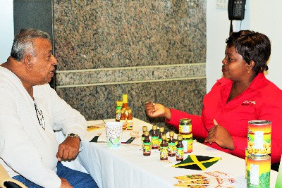 Ms. Denese Palmer, Managing Director, Southside Distributors (right) and Mr. Clarence Bagoo, CariCan International (left) discuss her products at JAMPRO's business forum in Toronto. 6 (six) Jamaican exporters displayed their products at the forum to Canadian distributors to increase their sales in that market. 