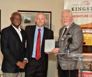 David Hall (centre), Executive Chairman of VIP Attractions, accepts The Priority Pass Award for Club Kingston, voted top Global Travel Lounge of the Year. Making the historic presentation is Terry Evans (right), President of Priority Pass. Sharing the occasion is Earl Richards, Chief Executive Officer of the Norman Manley International Airport. 