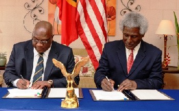 U.S. hammers St. Kitts and Nevis on corruption and money laundering - St. Kitts and Nevis' PM Hon. Timothy Harris, Larry S. Palmer signs FACTA agreement
