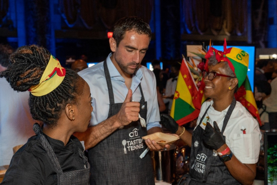 US Open champion Marin Cilic walks past the Grenada stand and praises Chef Bishop's cooking
