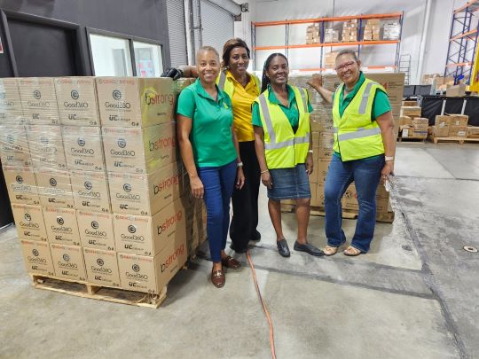 Members of Jamaican̈ Women of Florida busy packing pallets of emergency supplies for Caribbean islands struck by Hurricane Beryl.