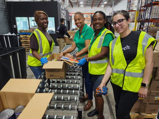 Members of Jamaican̈ Women of Florida busy packing pallets of emergency supplies for Caribbean islands struck by Hurricane Beryl.