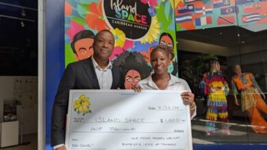 Fundraising Campaign at Island Space Caribbean Museum. Tamarac Vice Mayor Morey Wright Jr. presents a $1,000 check to Island SPACE president Calibe Thompson.